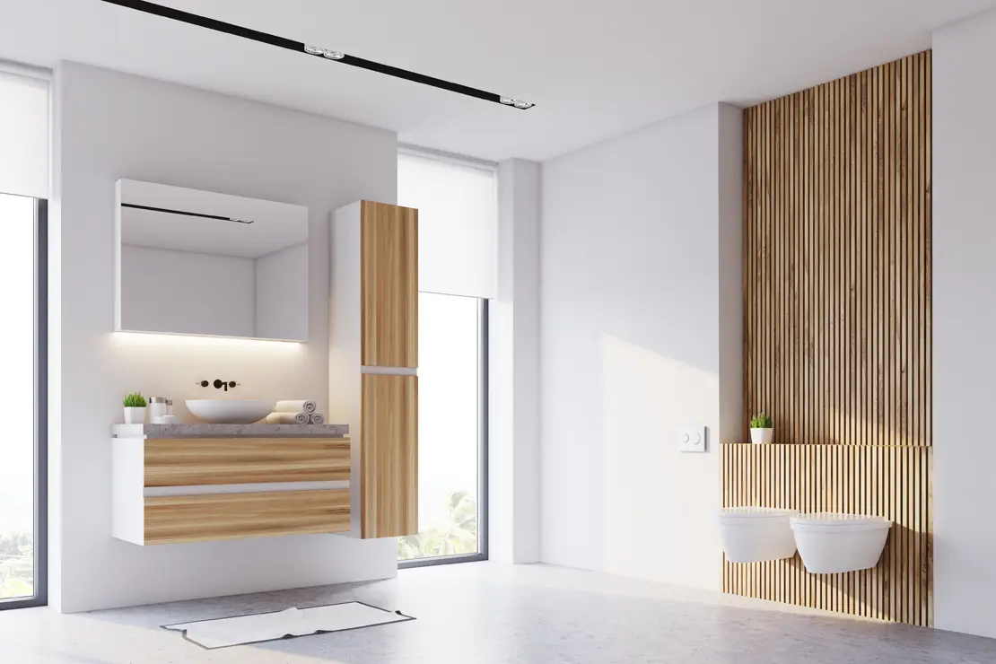 Aseo con piso de microcemento gris y componentes de madera. Aseo con piso de microcemento gris y componentes de madera.